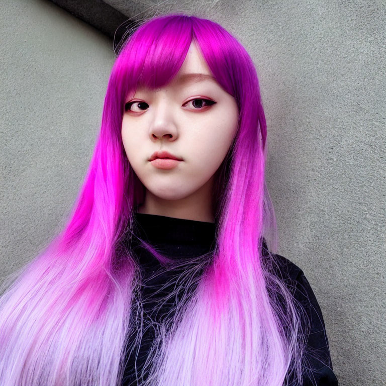 Striking purple hair and makeup against grey background.