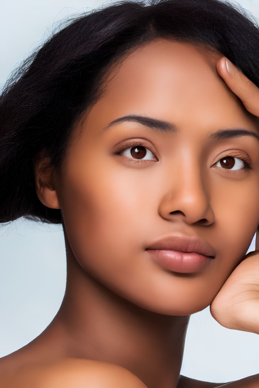 Serene woman portrait against light blue background