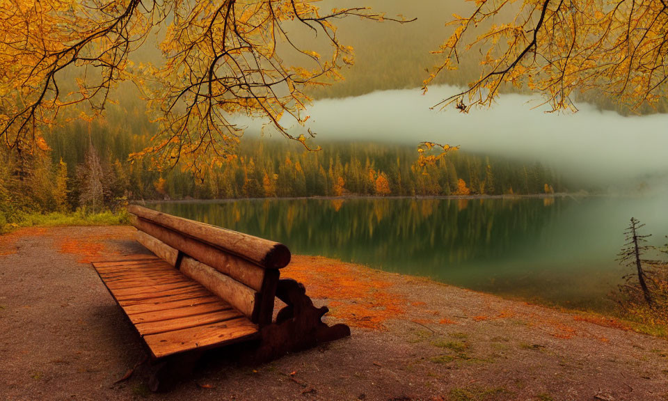 Tranquil autumn landscape with wooden bench by misty lake