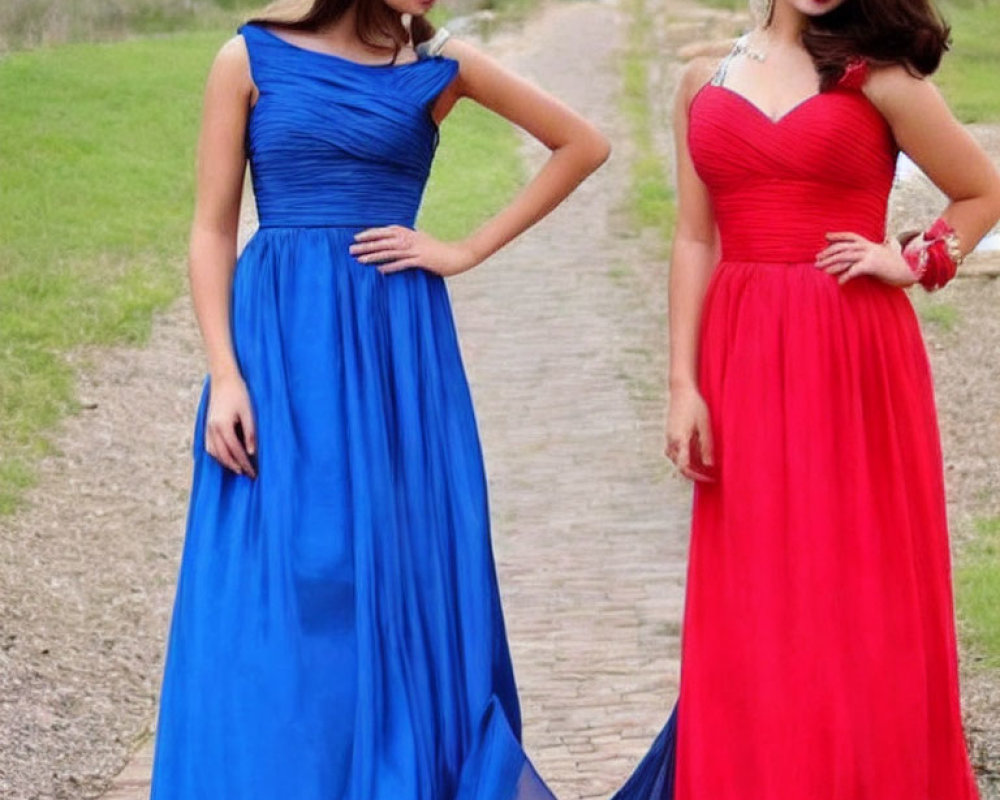 Two women in elegant blue and red gowns standing outdoors