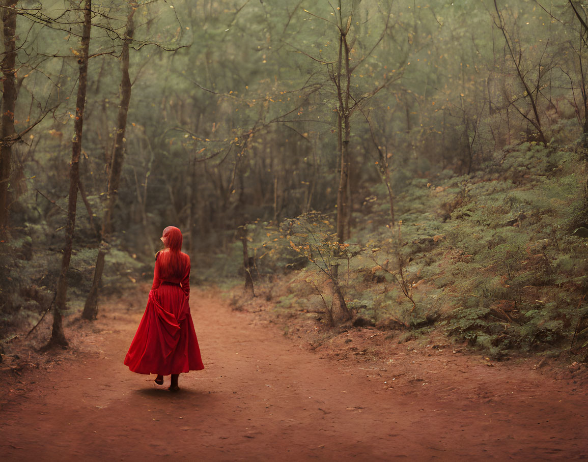 Red-haired woman in flowing dress stands in misty forest with split path