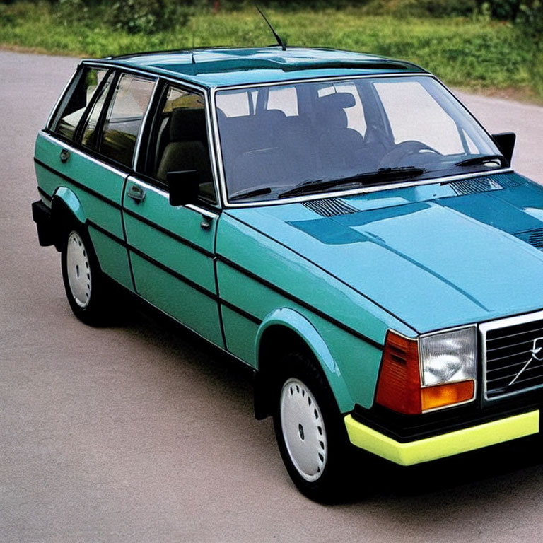 Vintage Blue Volvo Station Wagon on Paved Road with Greenery