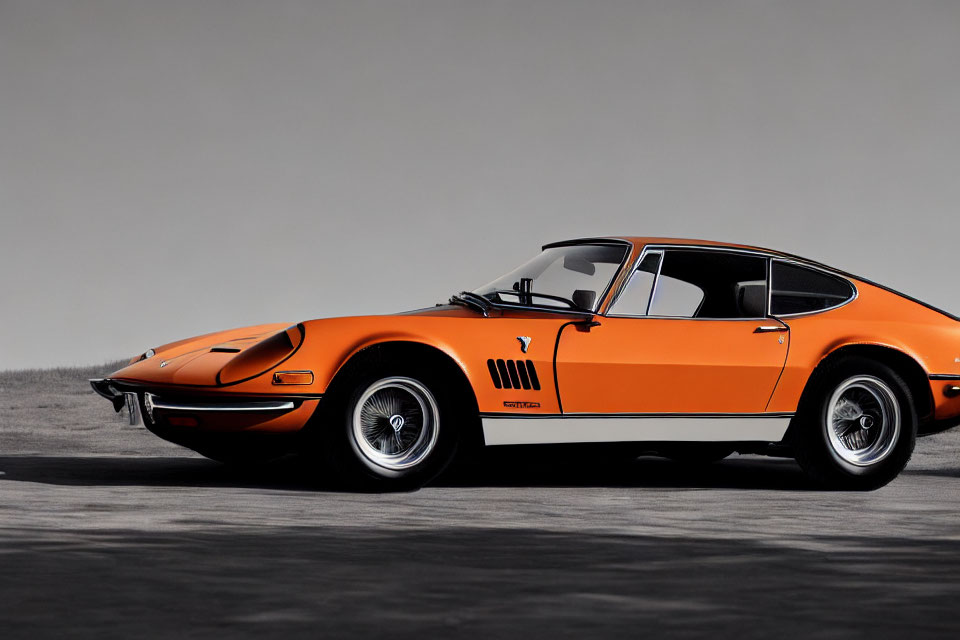 Vintage Orange Sports Car with Sleek Design Parked on Gray Ground