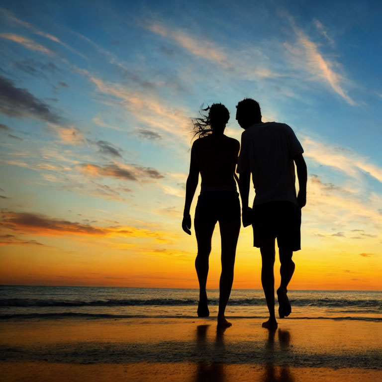 Romantic couple walking on beach at sunset with colorful sky and water reflection