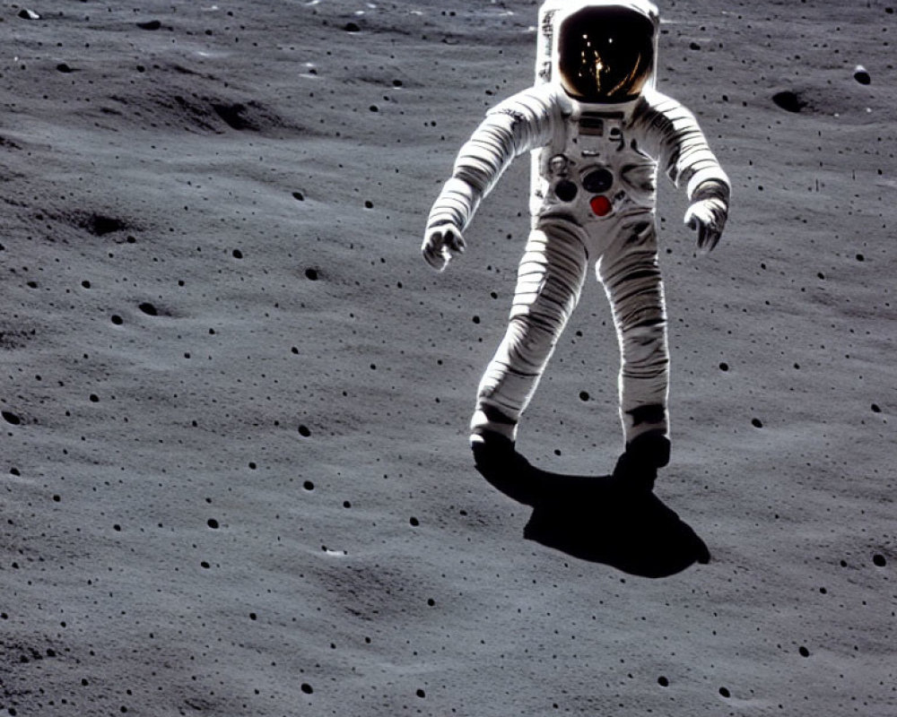 Astronaut in white space suit on moon's dark, cratered surface