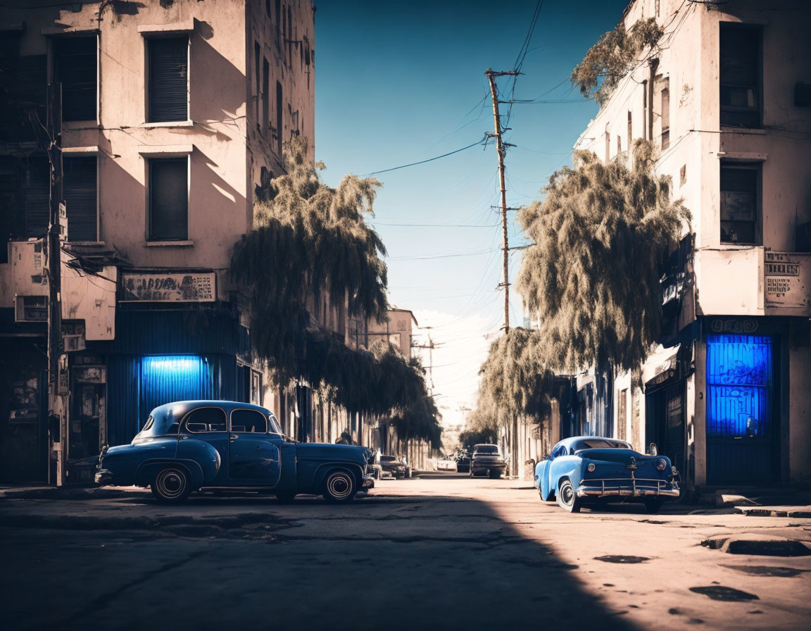 Vintage blue car parked on deserted street with buildings and overhanging trees