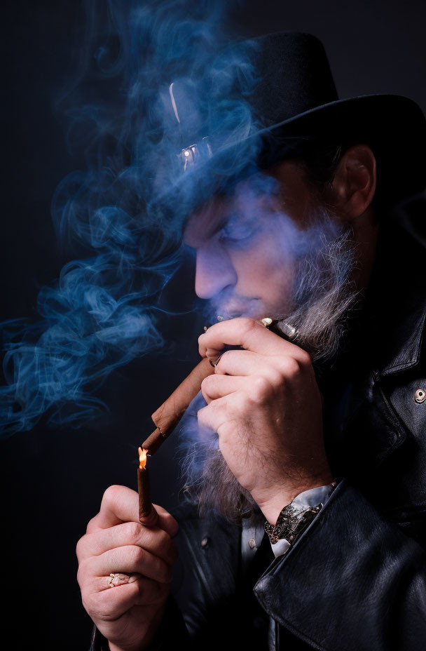 Man in Fedora Lighting Cigar Surrounded by Blue Smoke