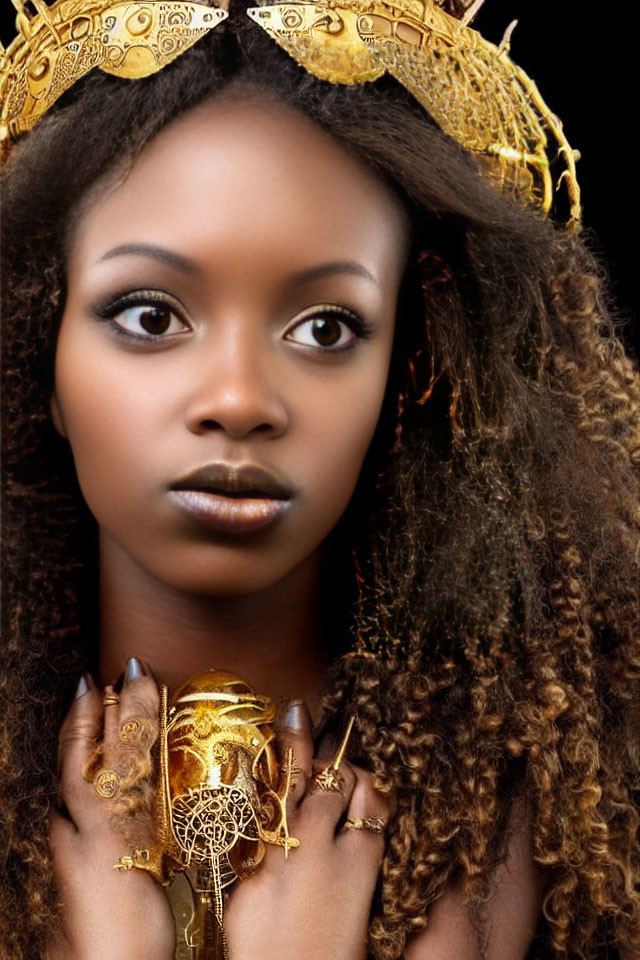 Striking-eyed woman in golden headdress and jewelry with intricate gold designs