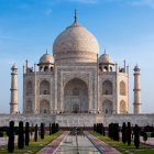 Iconic Taj Mahal with reflective pool and clear blue sky.