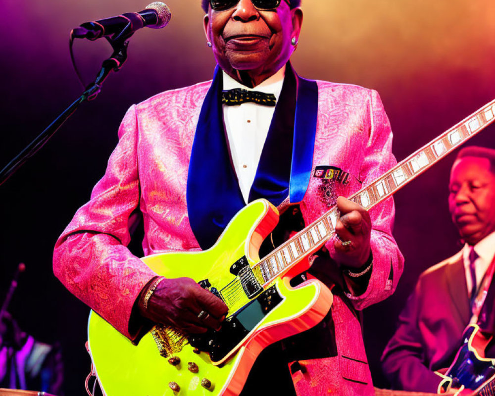 Musician in Pink Suit Plays Neon Yellow Guitar on Stage
