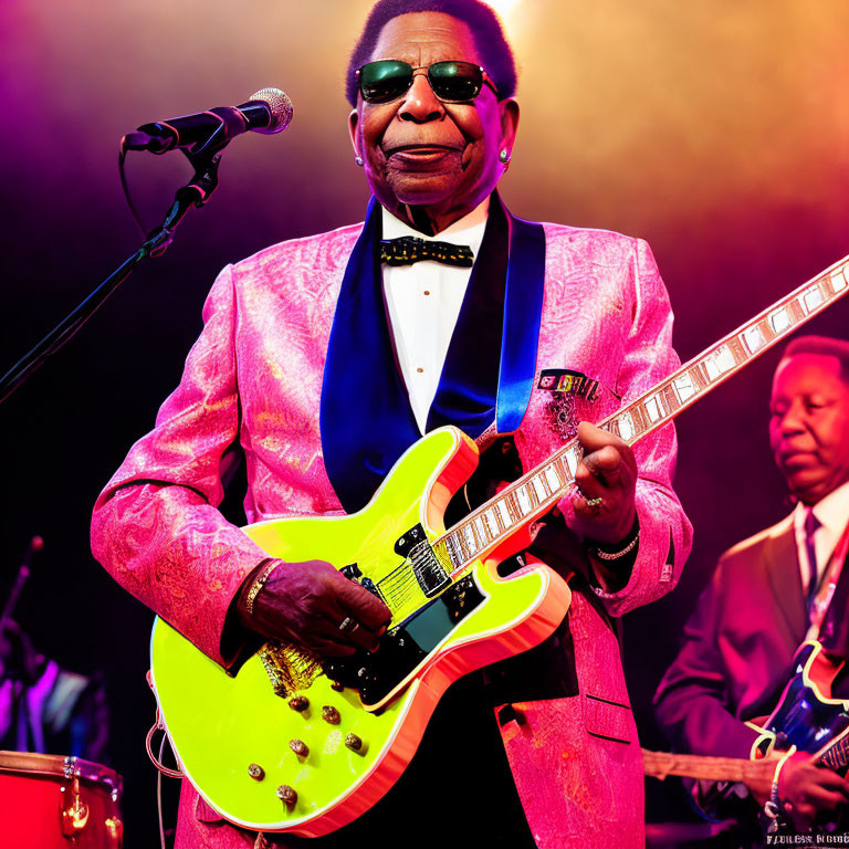 Musician in Pink Suit Plays Neon Yellow Guitar on Stage