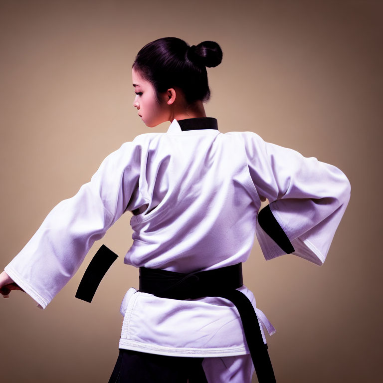 Martial Artist in White Gi and Black Belt Stance