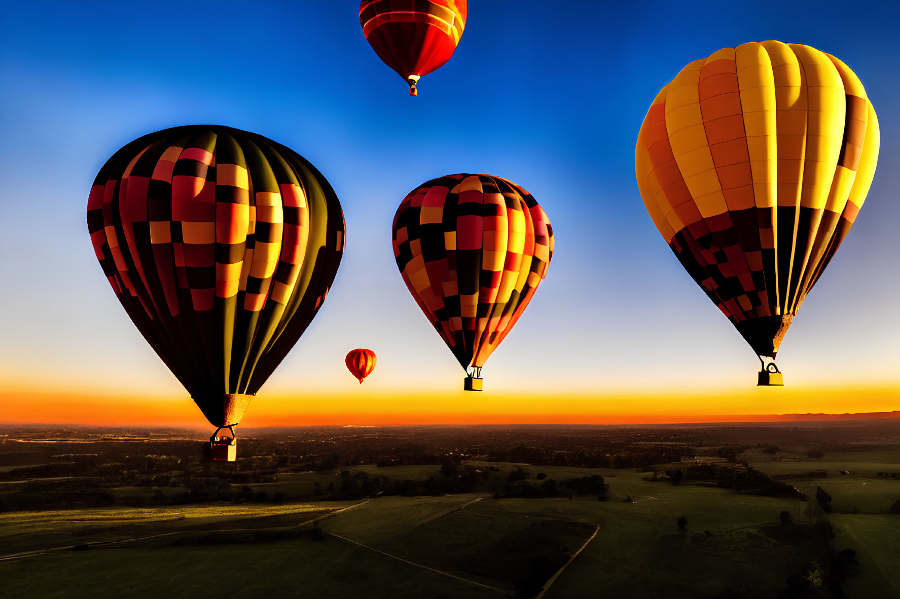 Sunset hot air balloons flying over clear sky with orange horizon