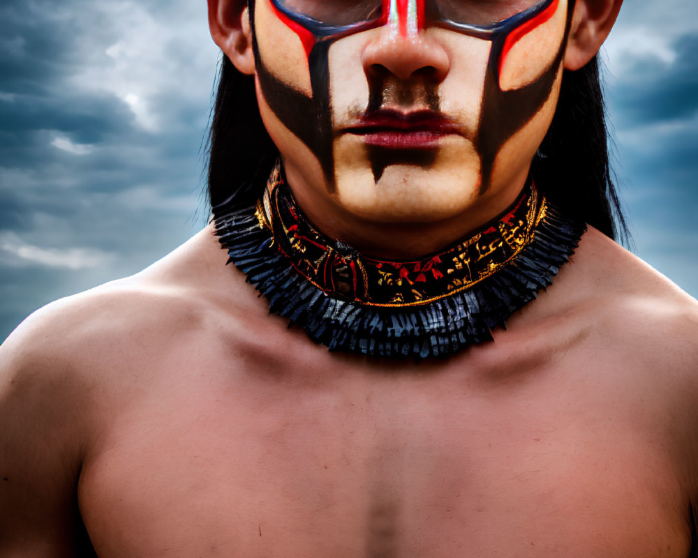 Shirtless man with red and black tribal face paint and beaded necklace against cloudy sky