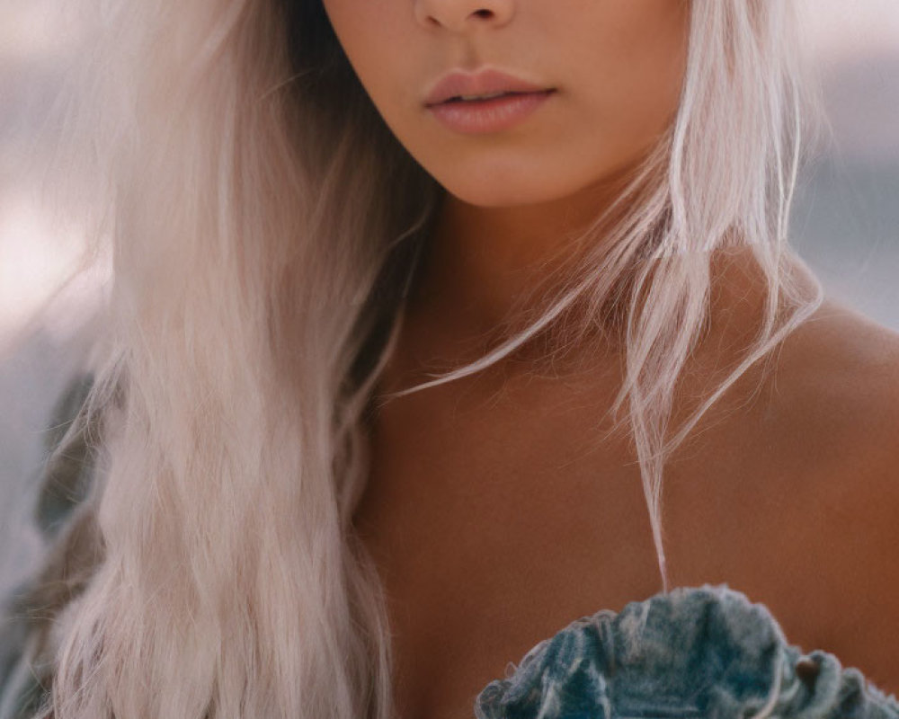 Blonde woman in denim jacket with striking eyes