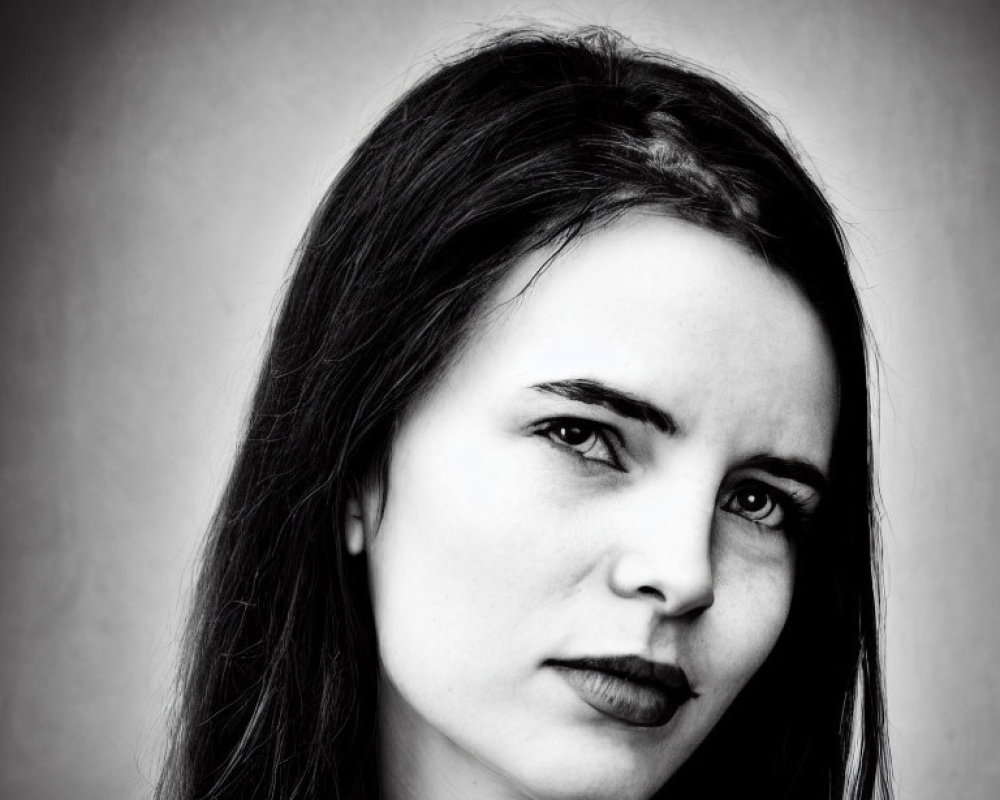 Monochrome portrait of woman with dark lipstick in pensive pose