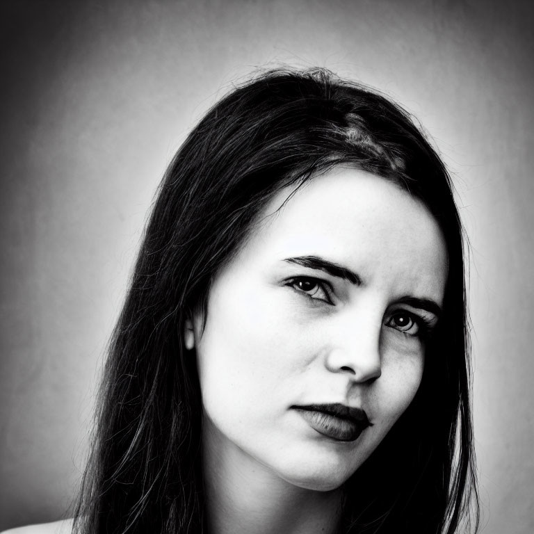 Monochrome portrait of woman with dark lipstick in pensive pose