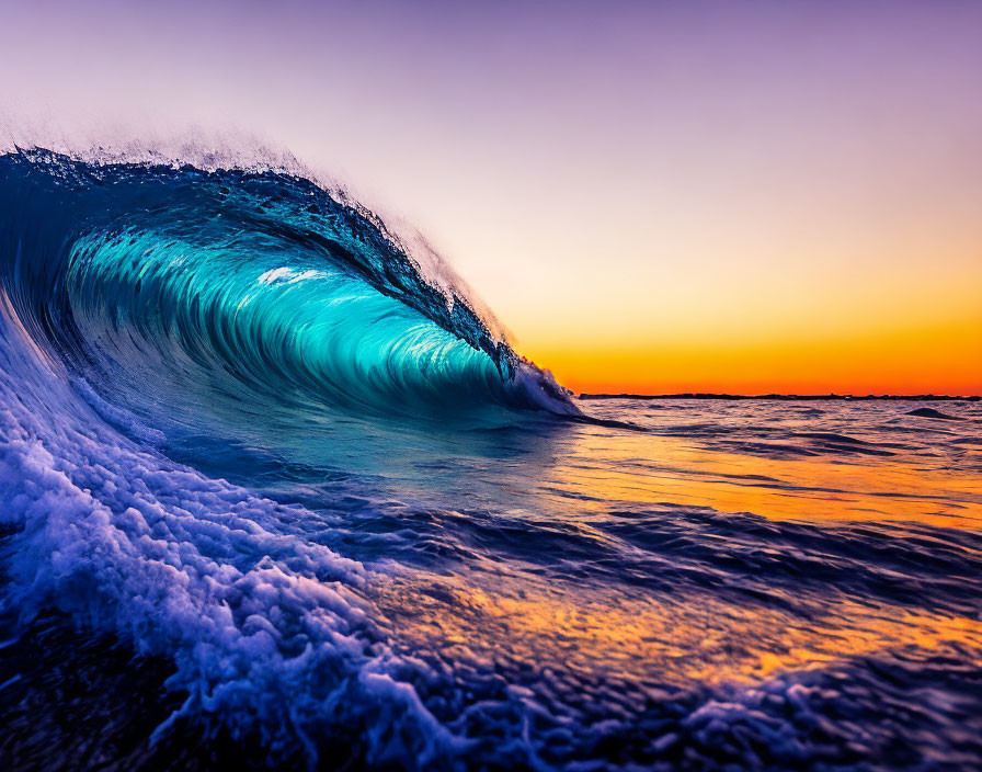 Sunset ocean wave with blue tones and white crest against colorful sky.