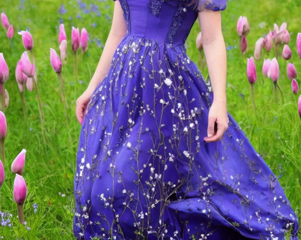 Person in Blue Dress Surrounded by Purple Tulips