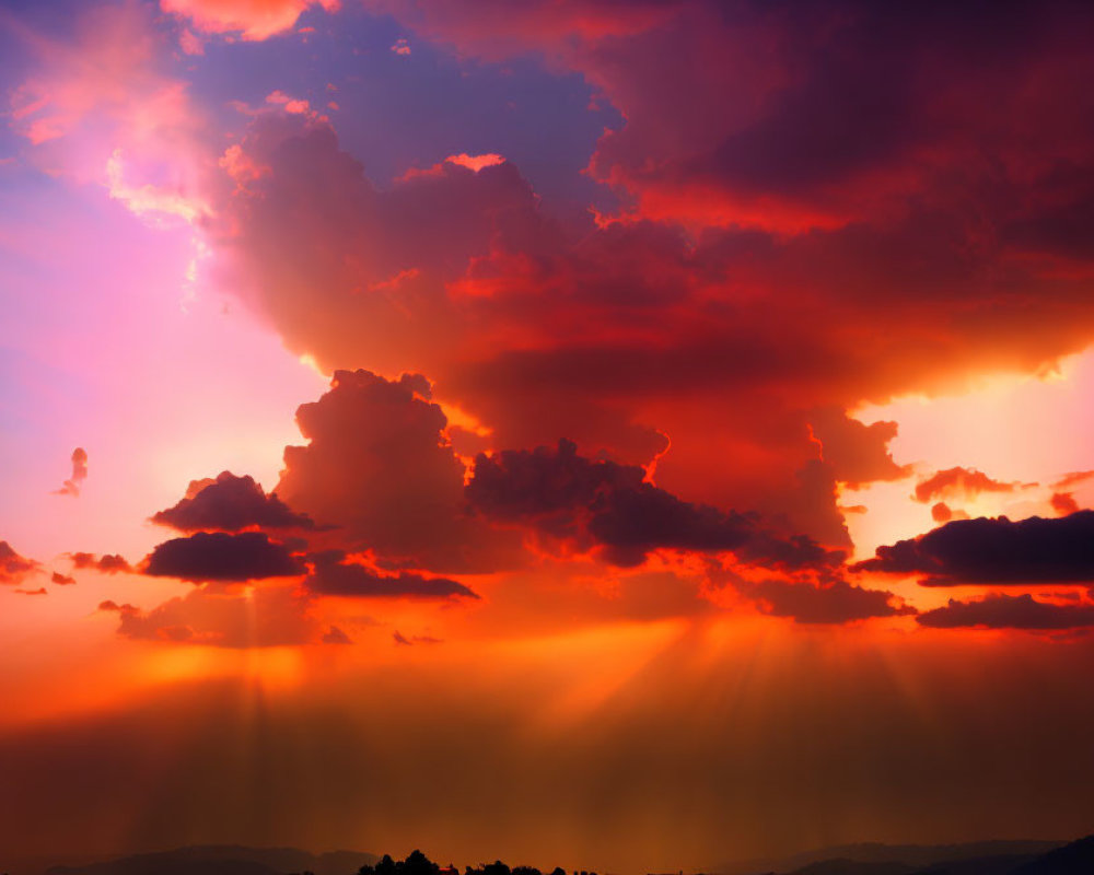 Vibrant sunset with radiant beams through orange and purple clouds