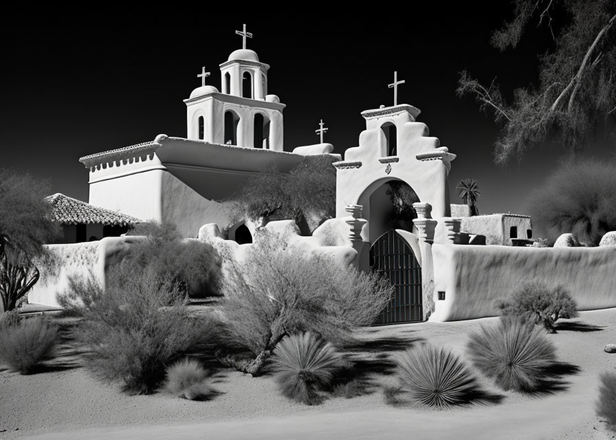 Spanish Mission-Style Church with Twin Bell Towers in Desert Landscape