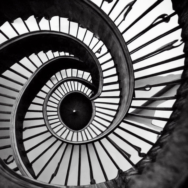 Monochrome spiral staircase photo from below with hypnotic pattern