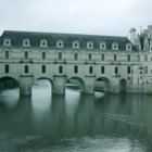 Majestic castle in misty landscape under dusky sky