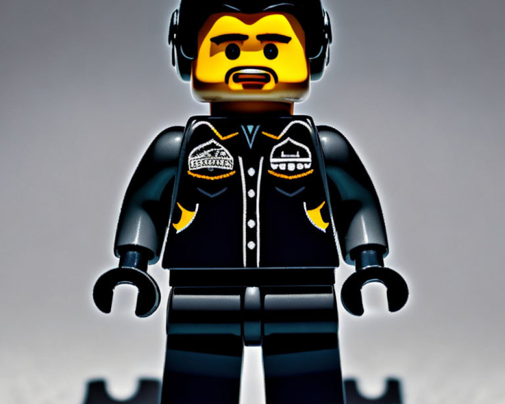 LEGO minifigure with beard in black jacket and badges