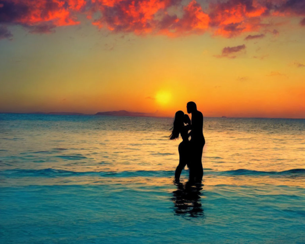 Silhouette of couple embracing in shallow water at vibrant sunset