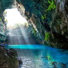 Mystical blue stream in cavern with fiery orange lights