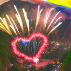 Colorful heart-shaped fireworks light up misty mountain night sky with rainbow arch