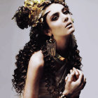 Portrait of a woman with dark curly hair and golden headdress holding a coin