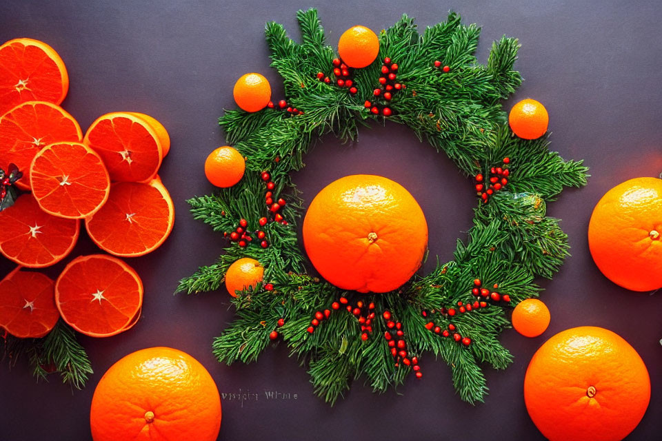 Green Pine and Red Berry Christmas Wreath with Oranges on Dark Background