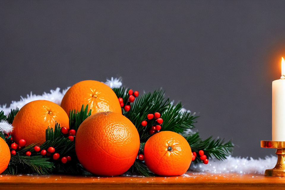 Festive orange and winter decor with pine branches and candle