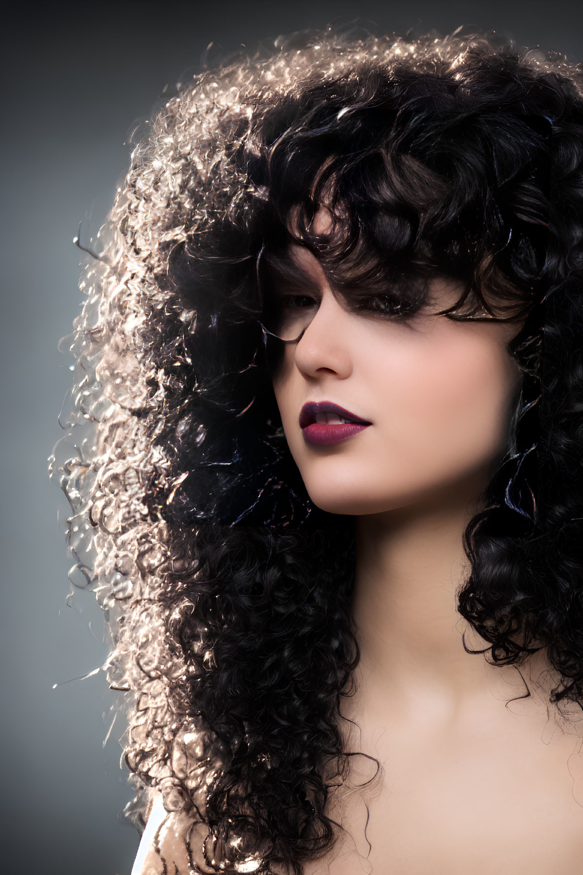 Portrait of a person with voluminous curly hair and dramatic makeup