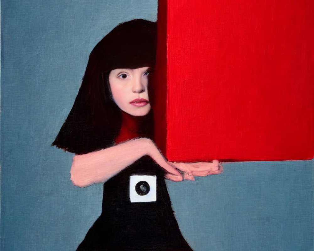 Young girl in black dress holding red square on blue backdrop