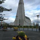 Gothic architecture church with pointed steeple under mixed sky