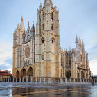 Majestic Gothic church in frosty landscape with snow-covered trees and river at sunrise