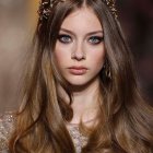 Young Woman with Long Wavy Brown Hair and Flowers Smiling gently