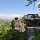 Tranquil Red Pagoda Landscape with Green Trees and Mountains