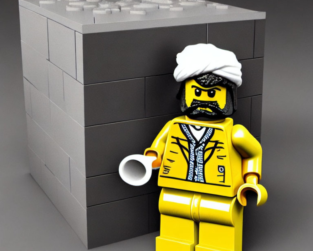 LEGO Figure in White Turban and Yellow Attire with Sunglasses by Grey Brick Wall