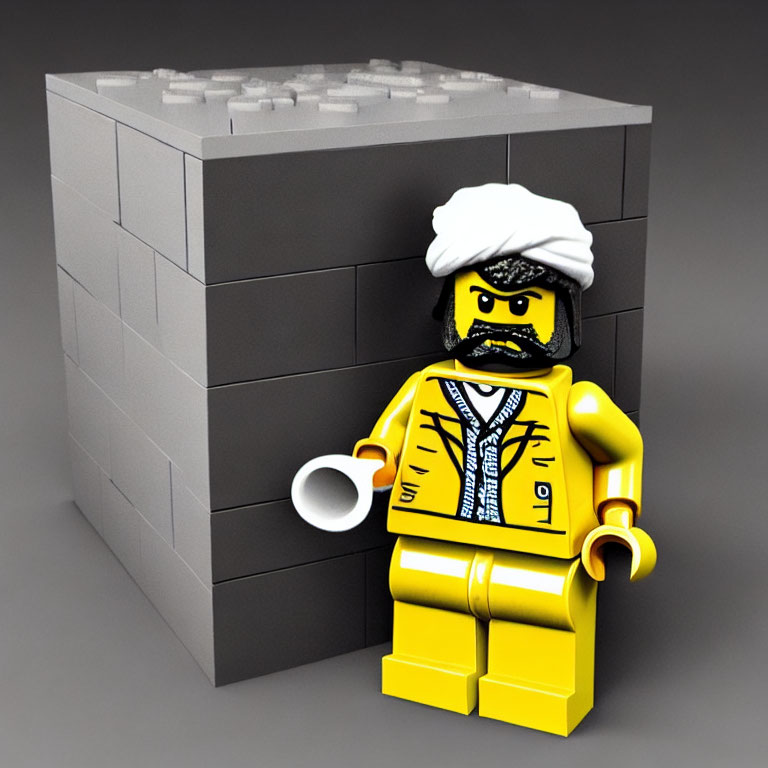 LEGO Figure in White Turban and Yellow Attire with Sunglasses by Grey Brick Wall