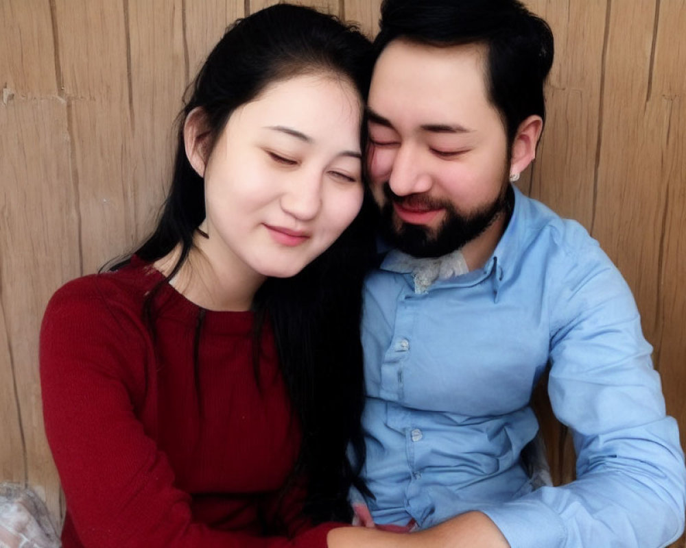 Smiling couple sitting closely together in tender moment