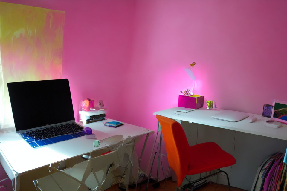 Colorful Home Office with Pink Wall, Laptop, Orange Chair, and Stationery