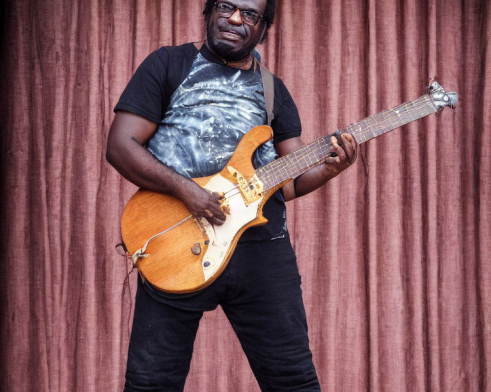 Man in Black Attire Playing Electric Guitar with Glasses