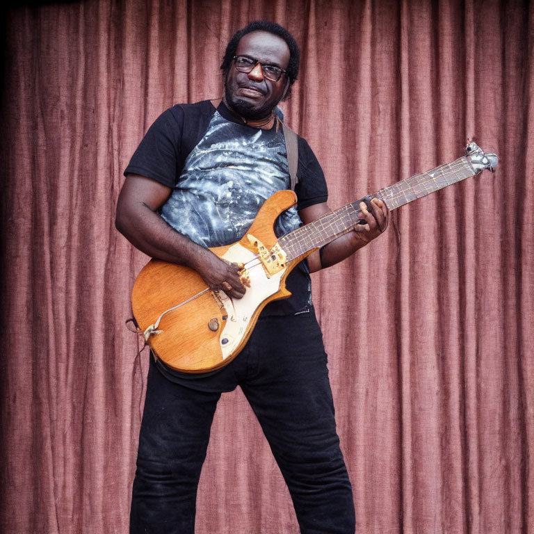 Man in Black Attire Playing Electric Guitar with Glasses