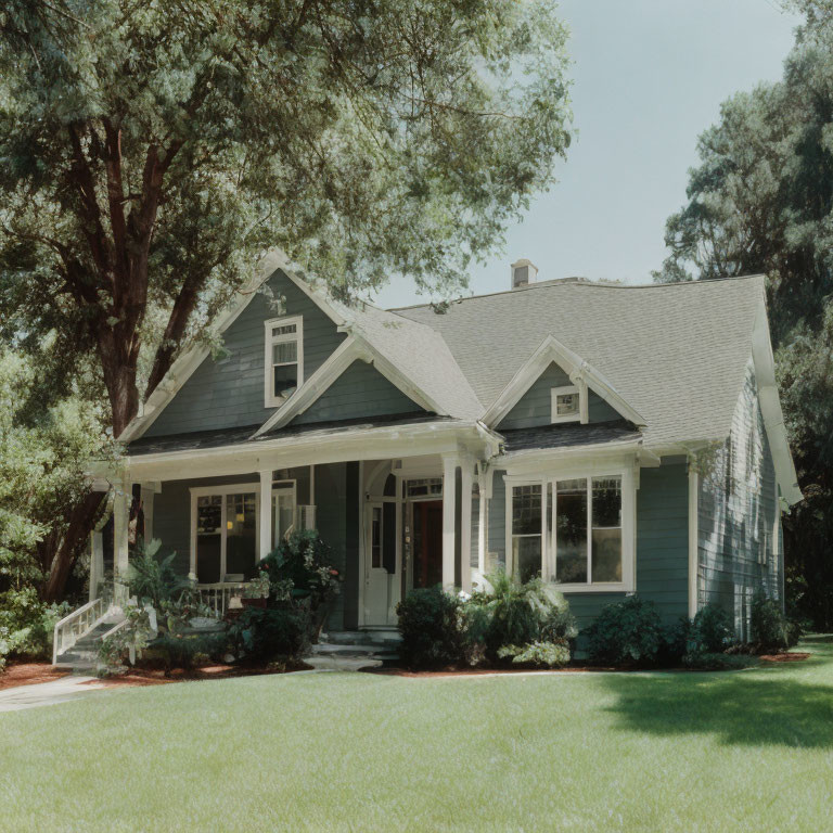 Quaint Green Single-Story House with Gabled Roof and Front Porch