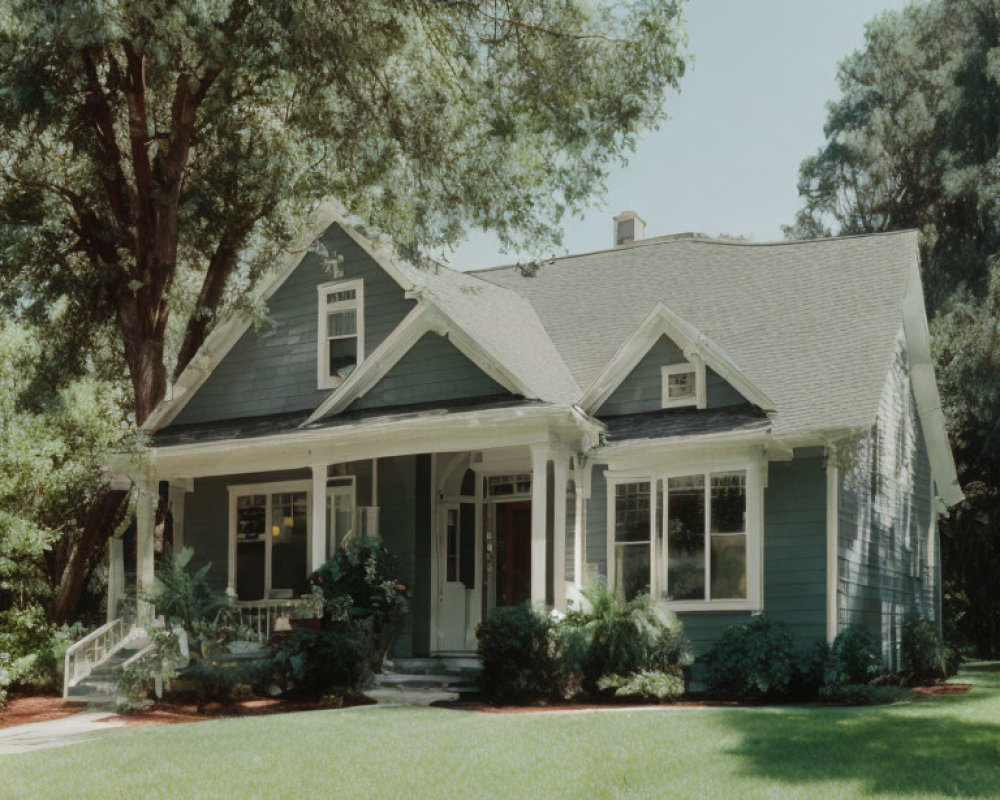 Quaint Green Single-Story House with Gabled Roof and Front Porch