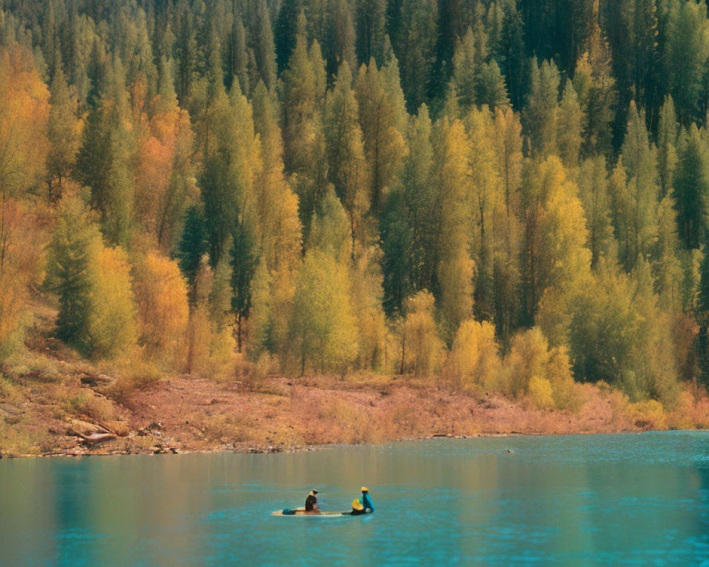 Kayaking on Turquoise Lake Amid Autumn Trees and Forested Hill