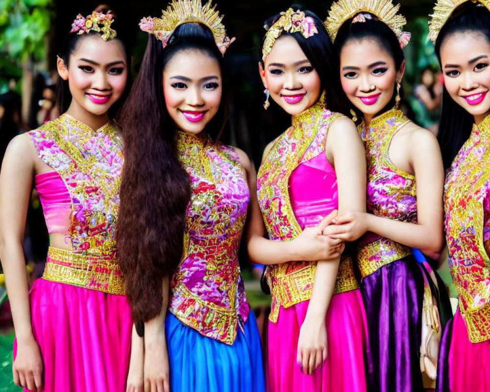 Four Women in Colorful Thai Attire and Floral Headpieces Outdoors